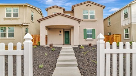 A white fence in front of a house.