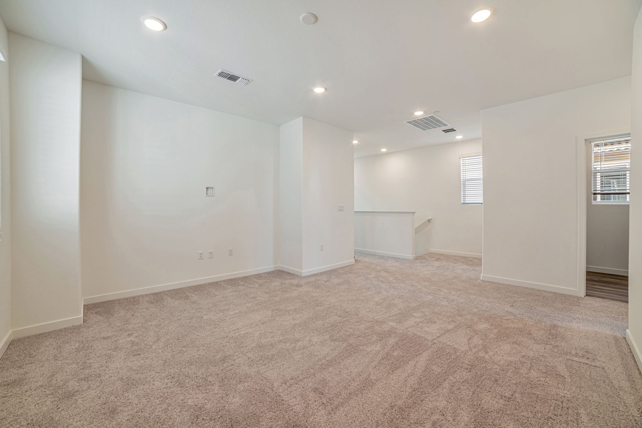 A room with a carpet and a rug.
