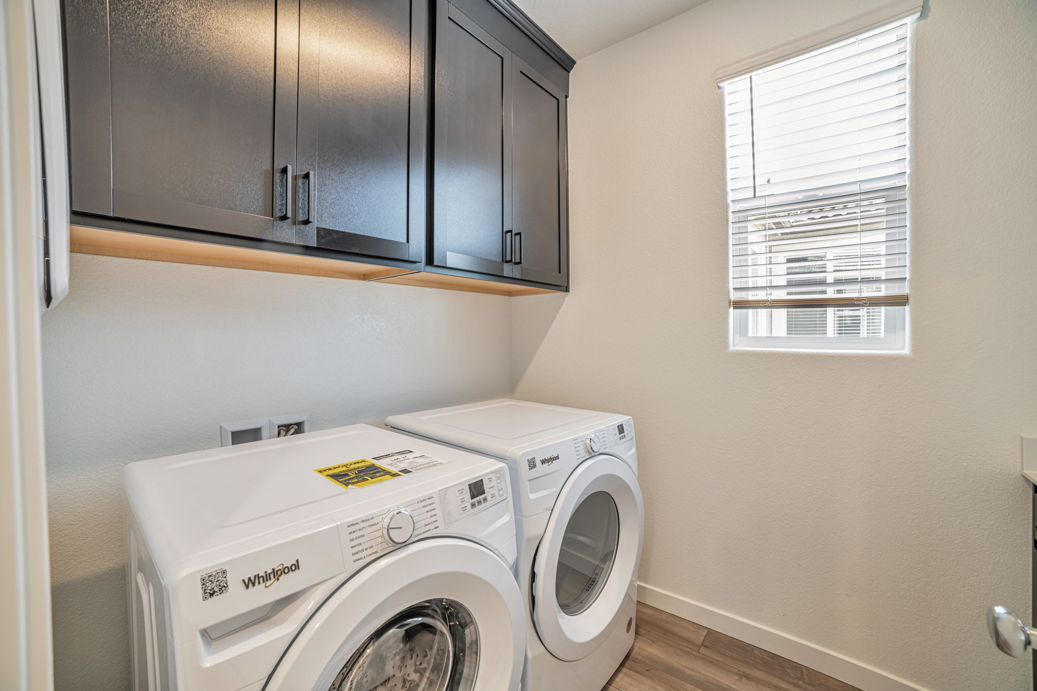 A washing machine and dryer in a room.
