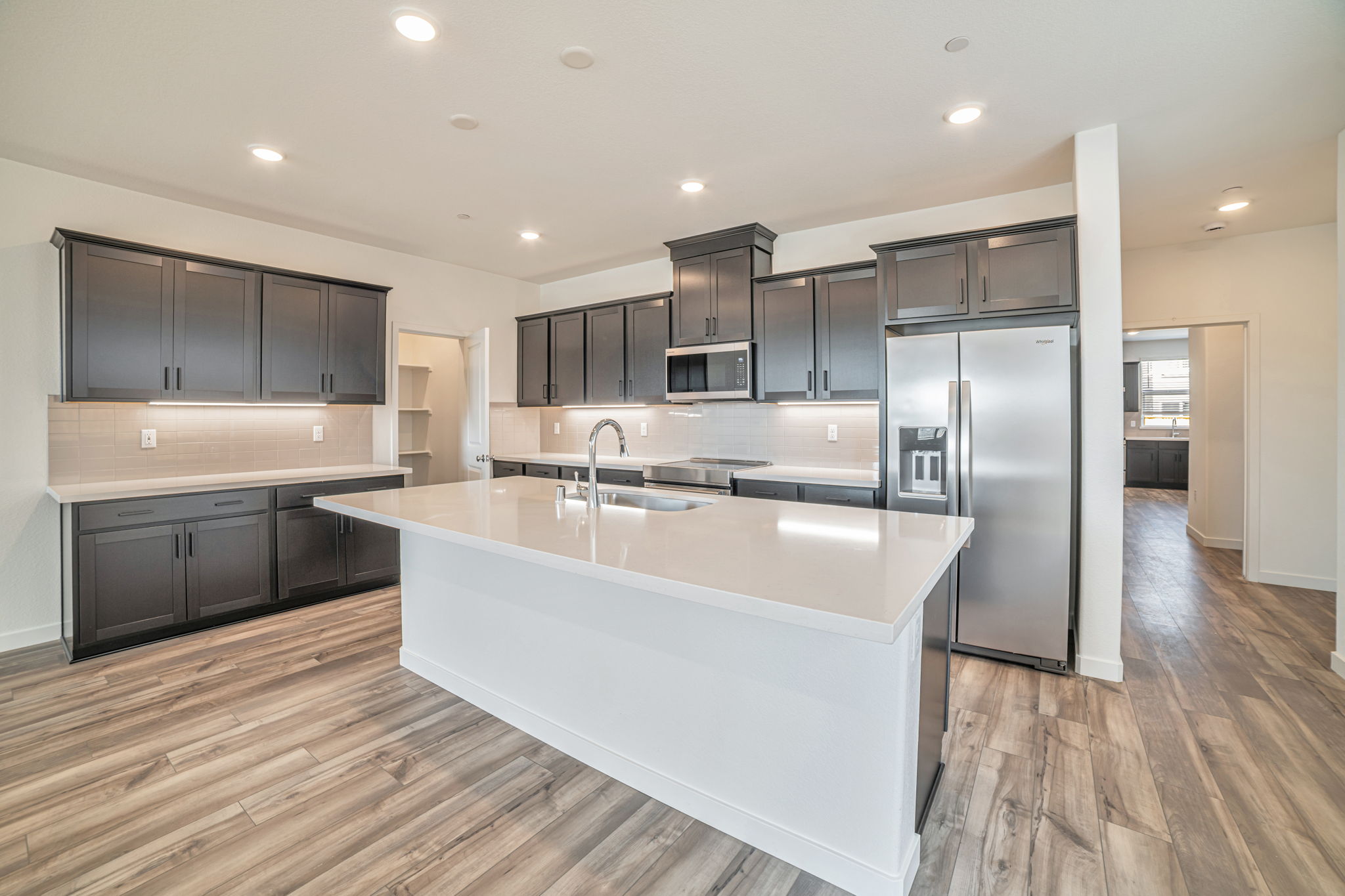 A kitchen with black cabinets.