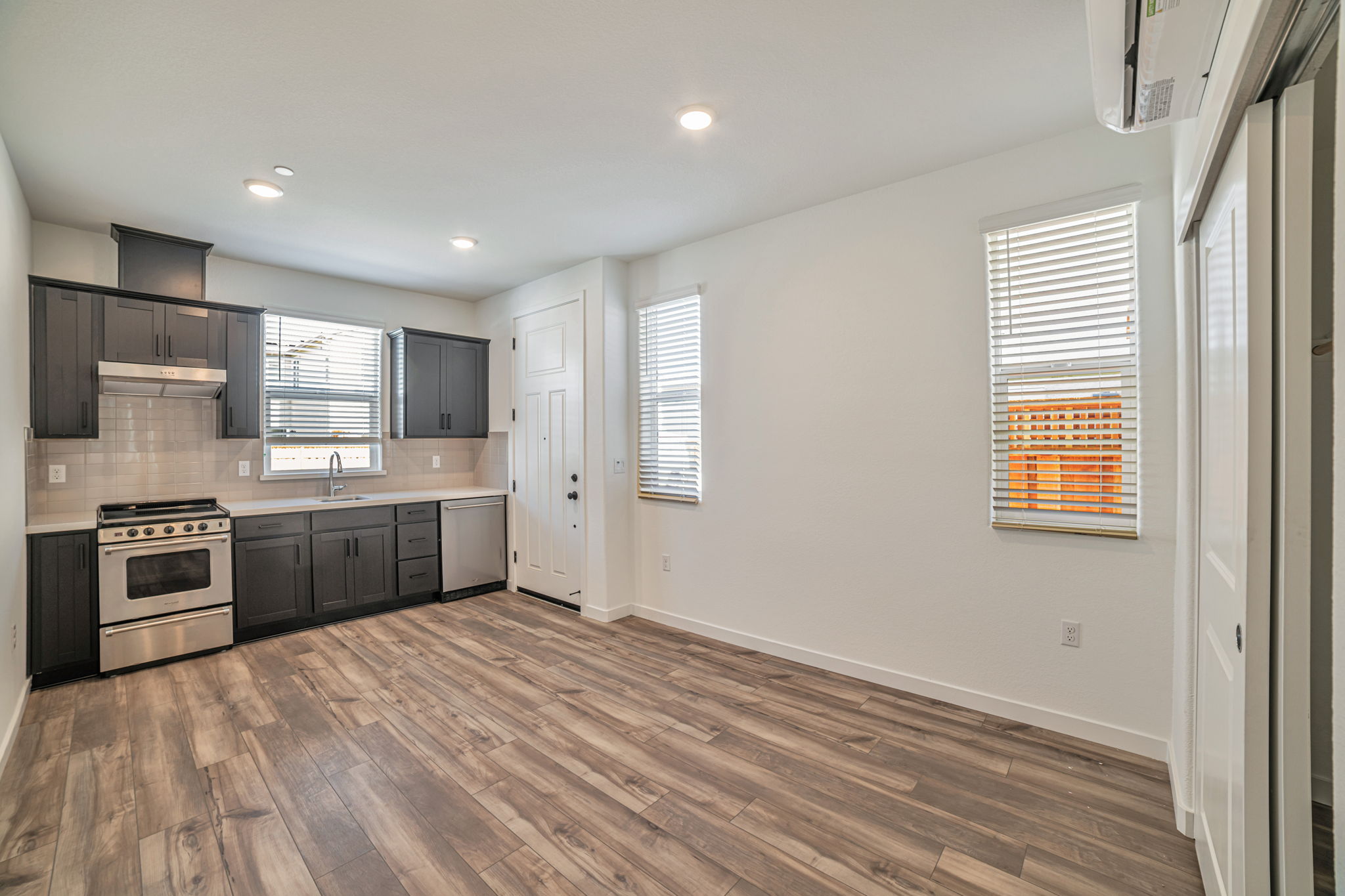 A kitchen with a wood floor.