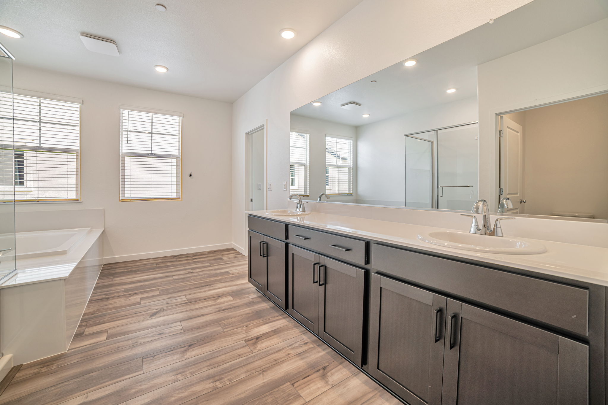 A bathroom with a large mirror.