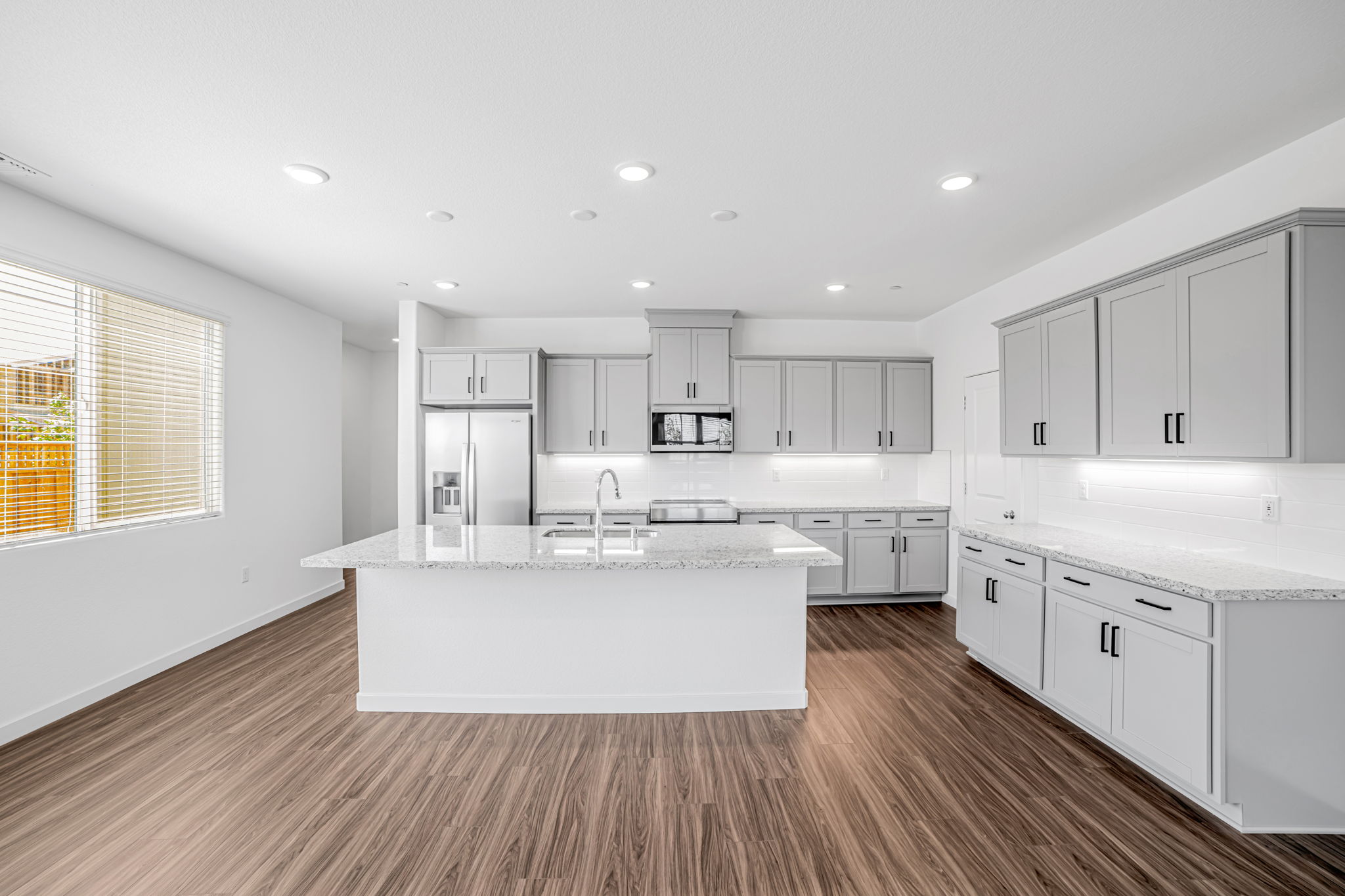 A kitchen with white cabinets.
