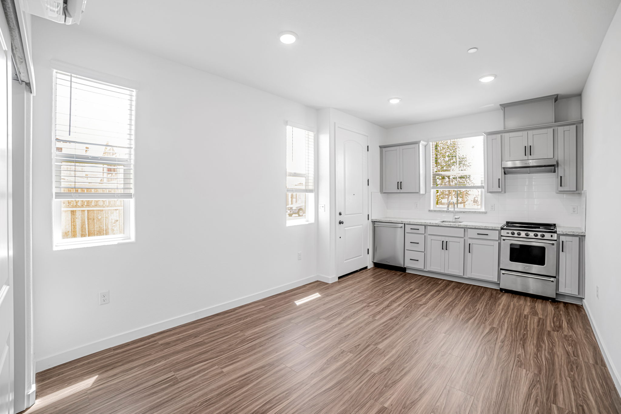 A kitchen with white cabinets.