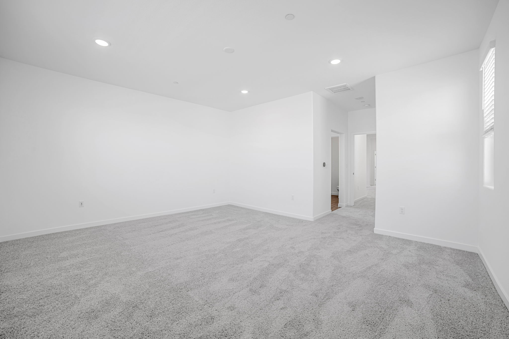A long hallway with white walls.
