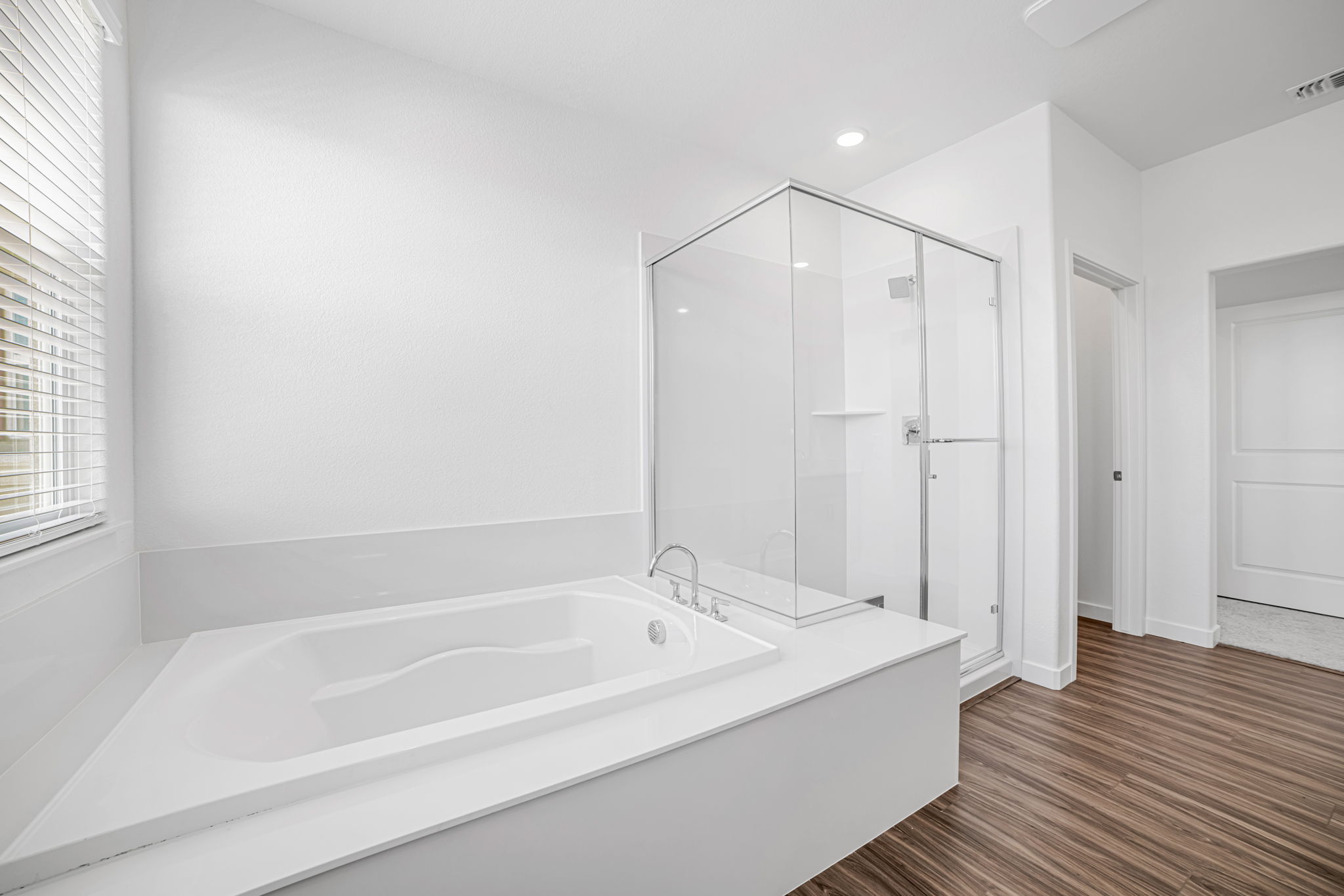 A white bathroom with a glass shower.