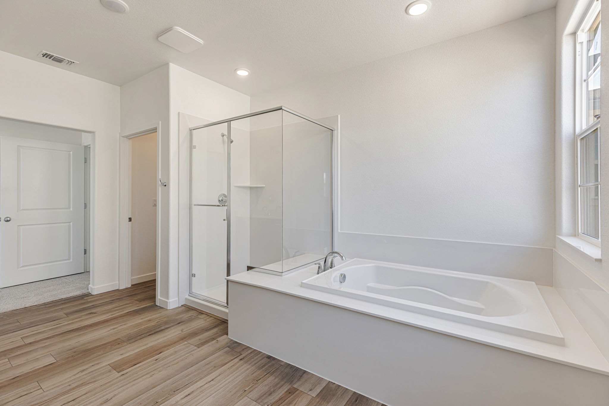 A bathroom with a tub and shower.