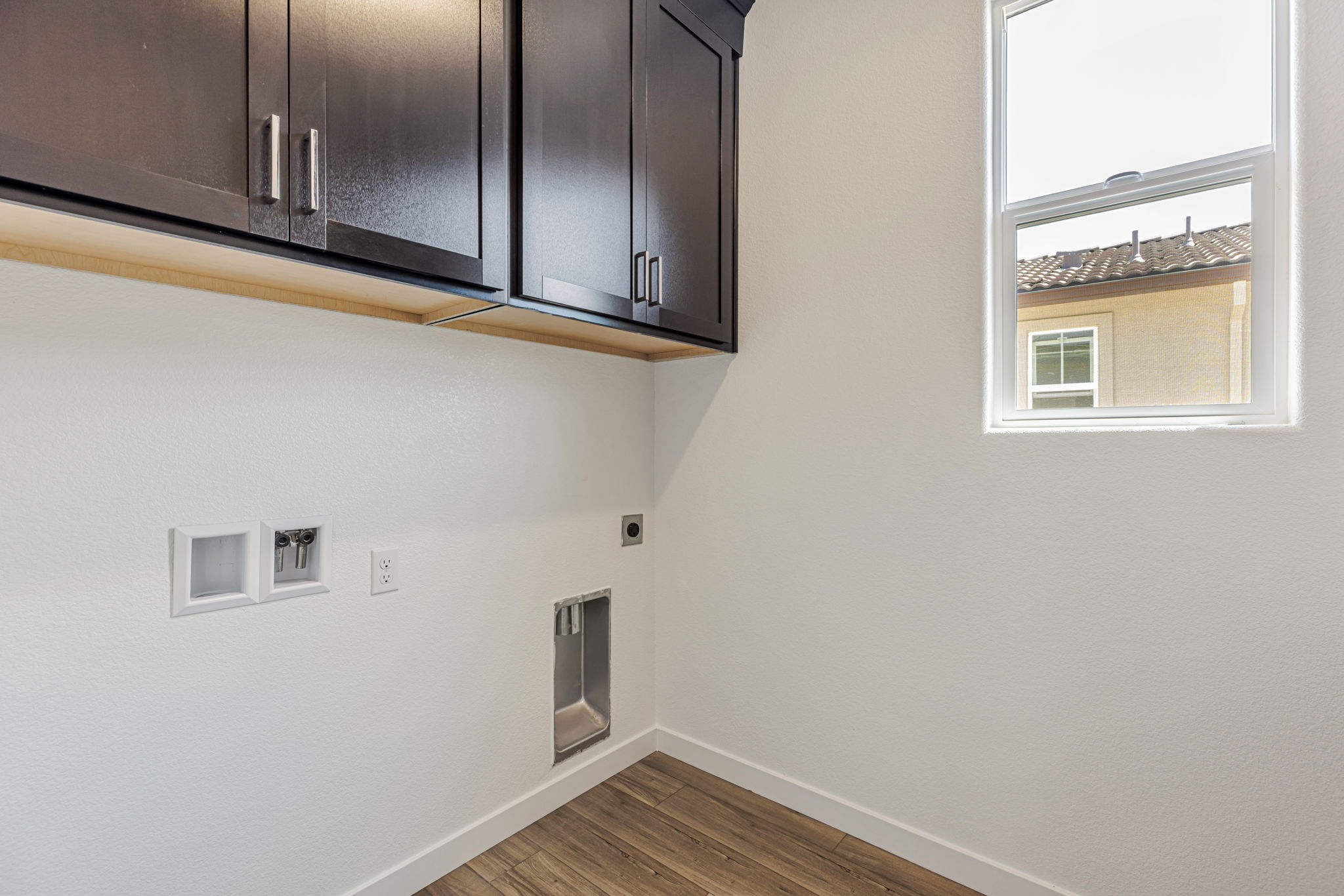 A room with a window and cabinets.