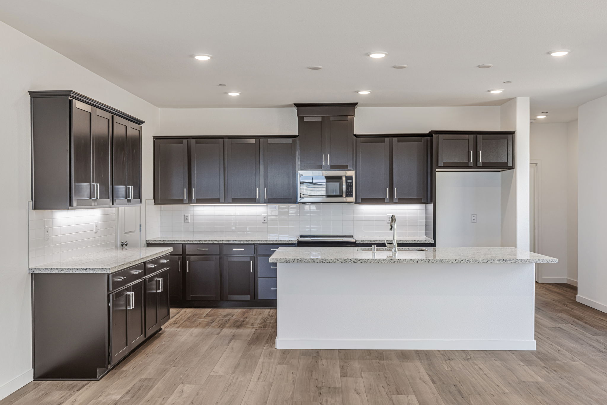 A kitchen with black cabinets.