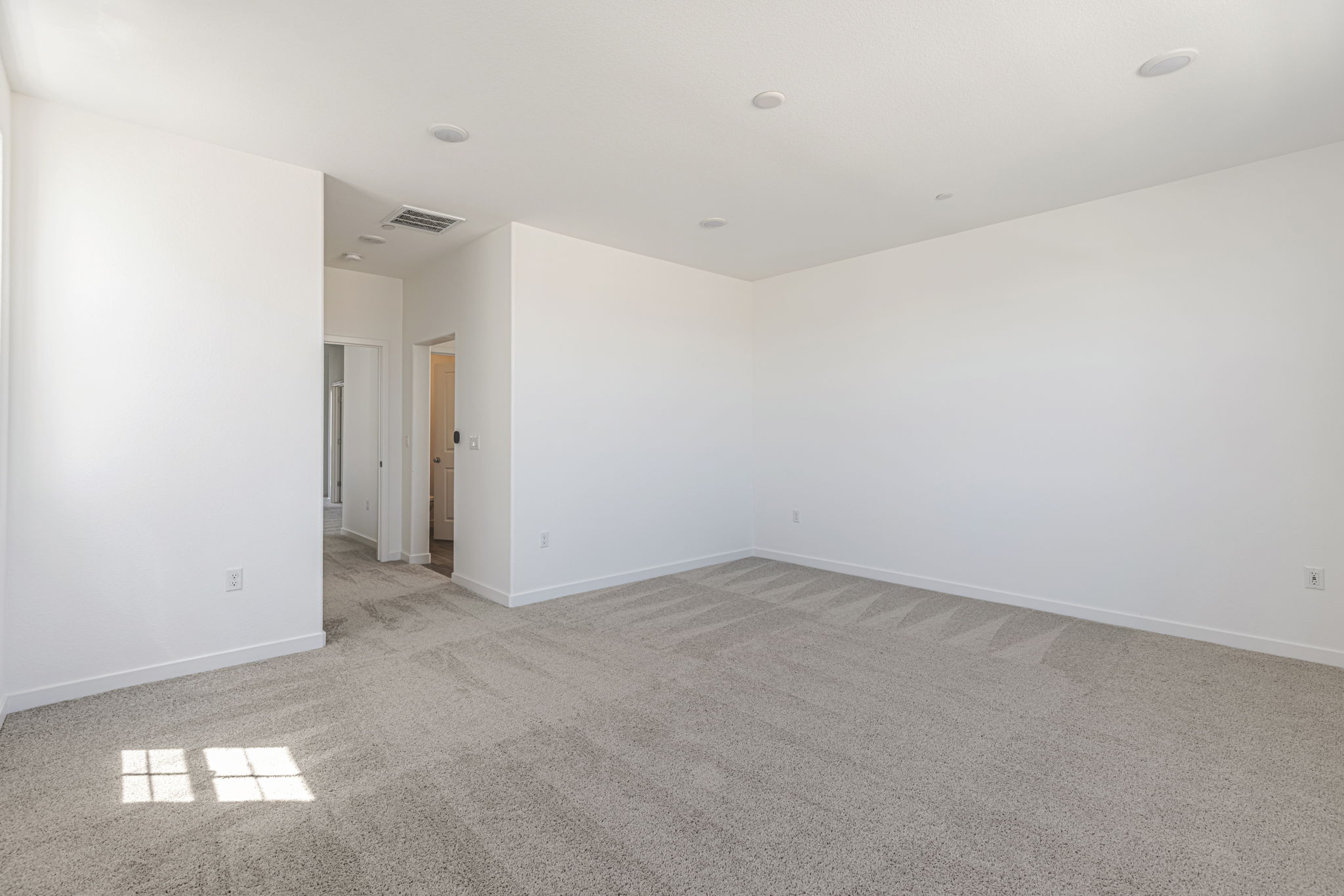 A long hallway with white walls.