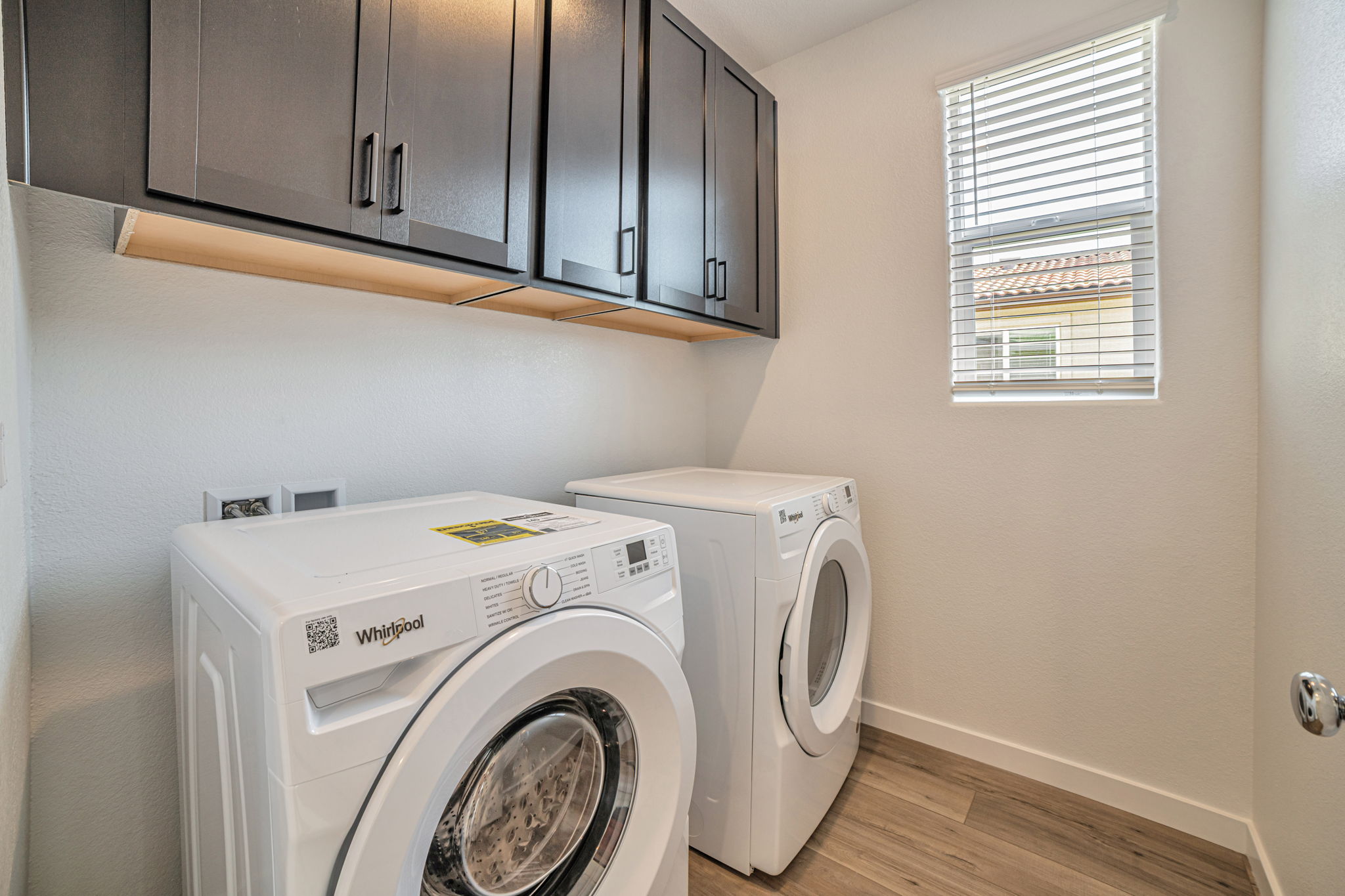 A washing machine and dryer in a room.