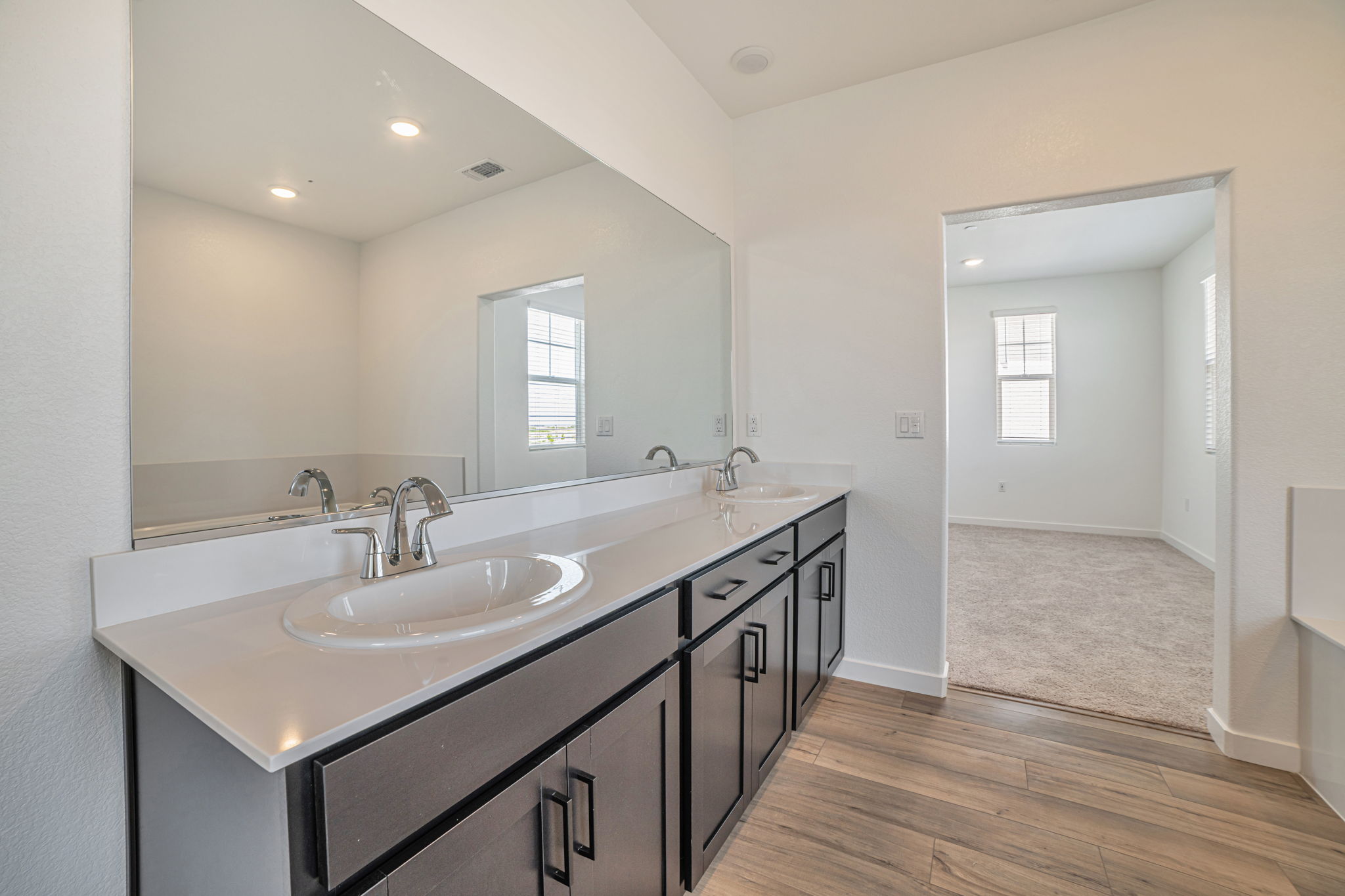 A bathroom with a large mirror.
