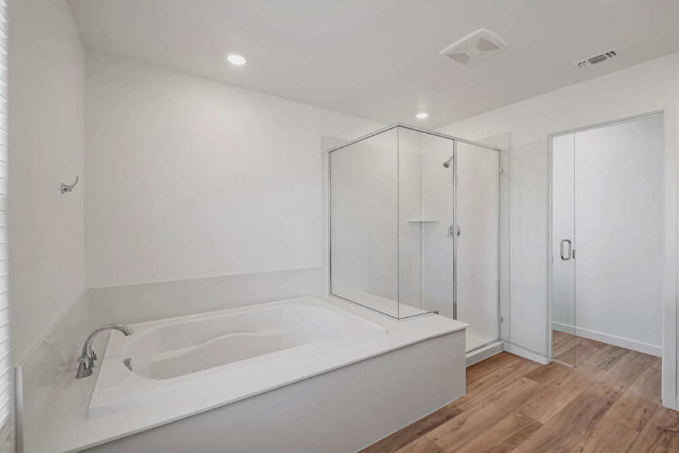 A bathroom with a tub and shower.