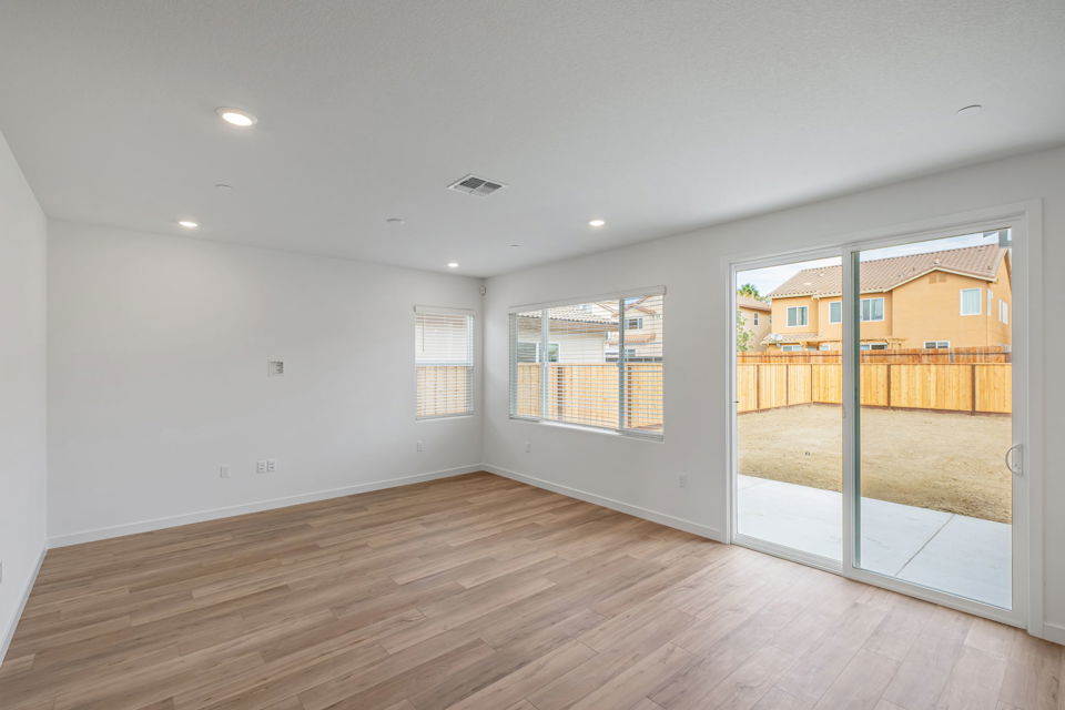 A room with a wood floor and a wood floor with a wood railing.