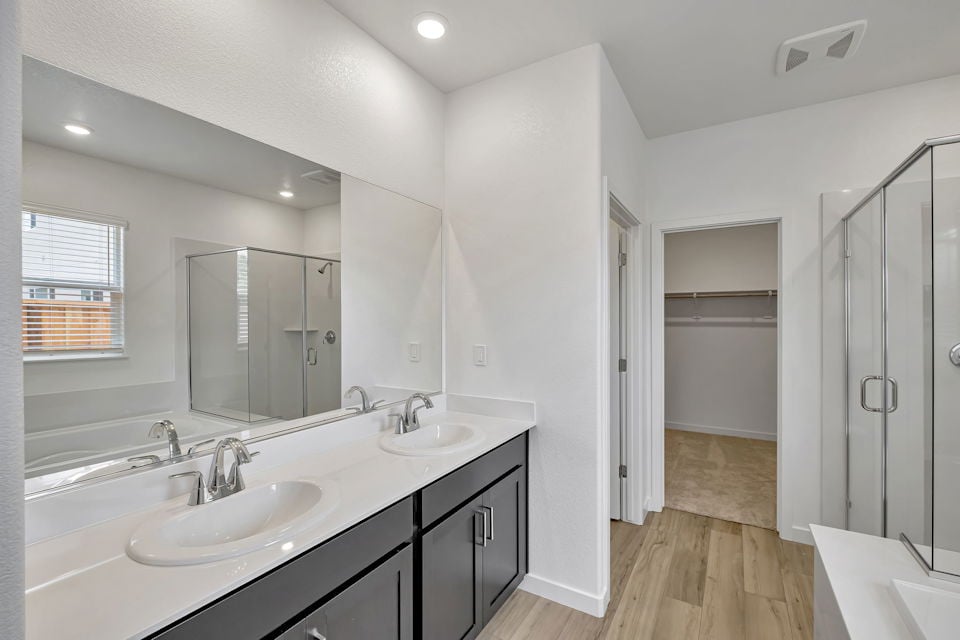 A bathroom with a large mirror.