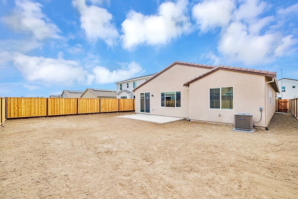 A house with a dirt yard.