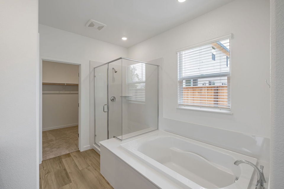 A bathroom with a tub and shower.