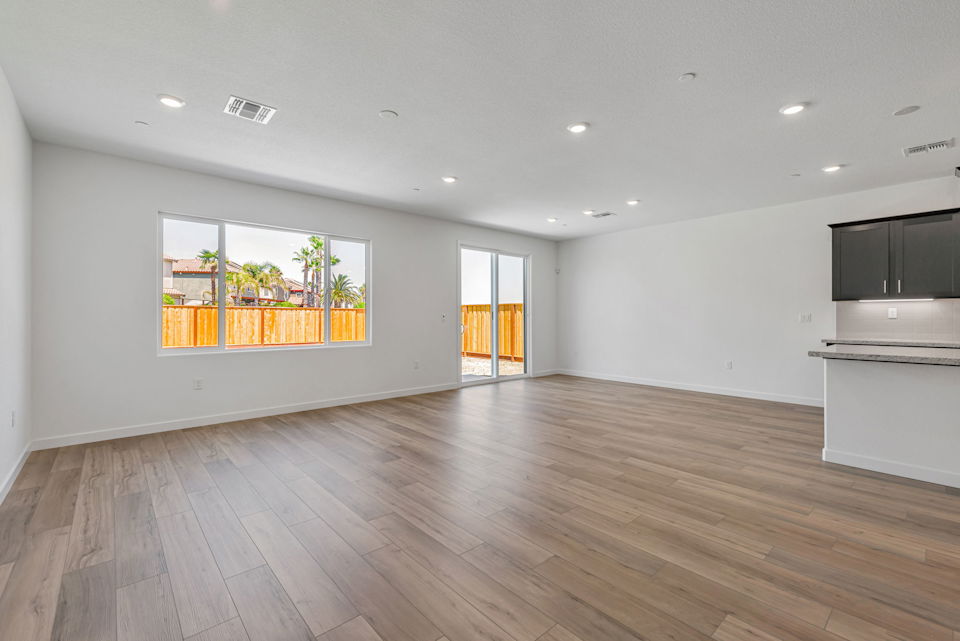 A room with a wood floor and a large window.