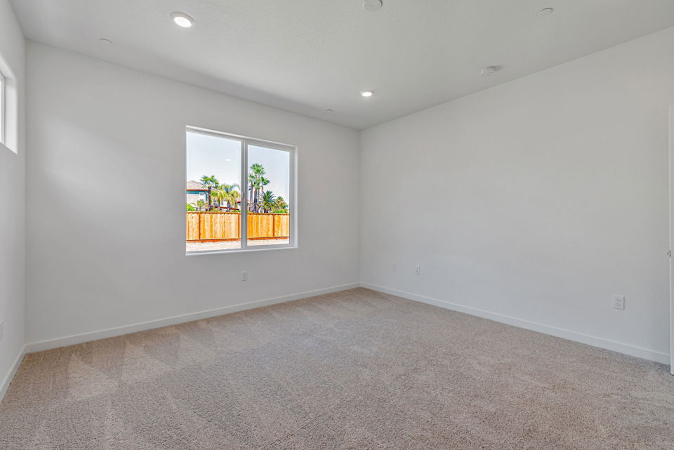 A room with a window and a carpet.