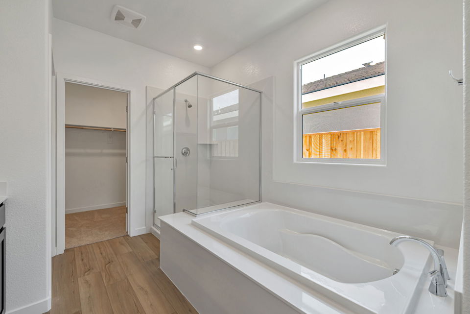 A bathroom with a tub and shower.