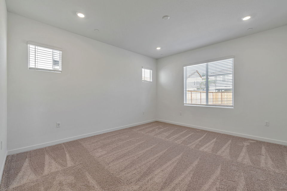 A room with a carpet and a window.