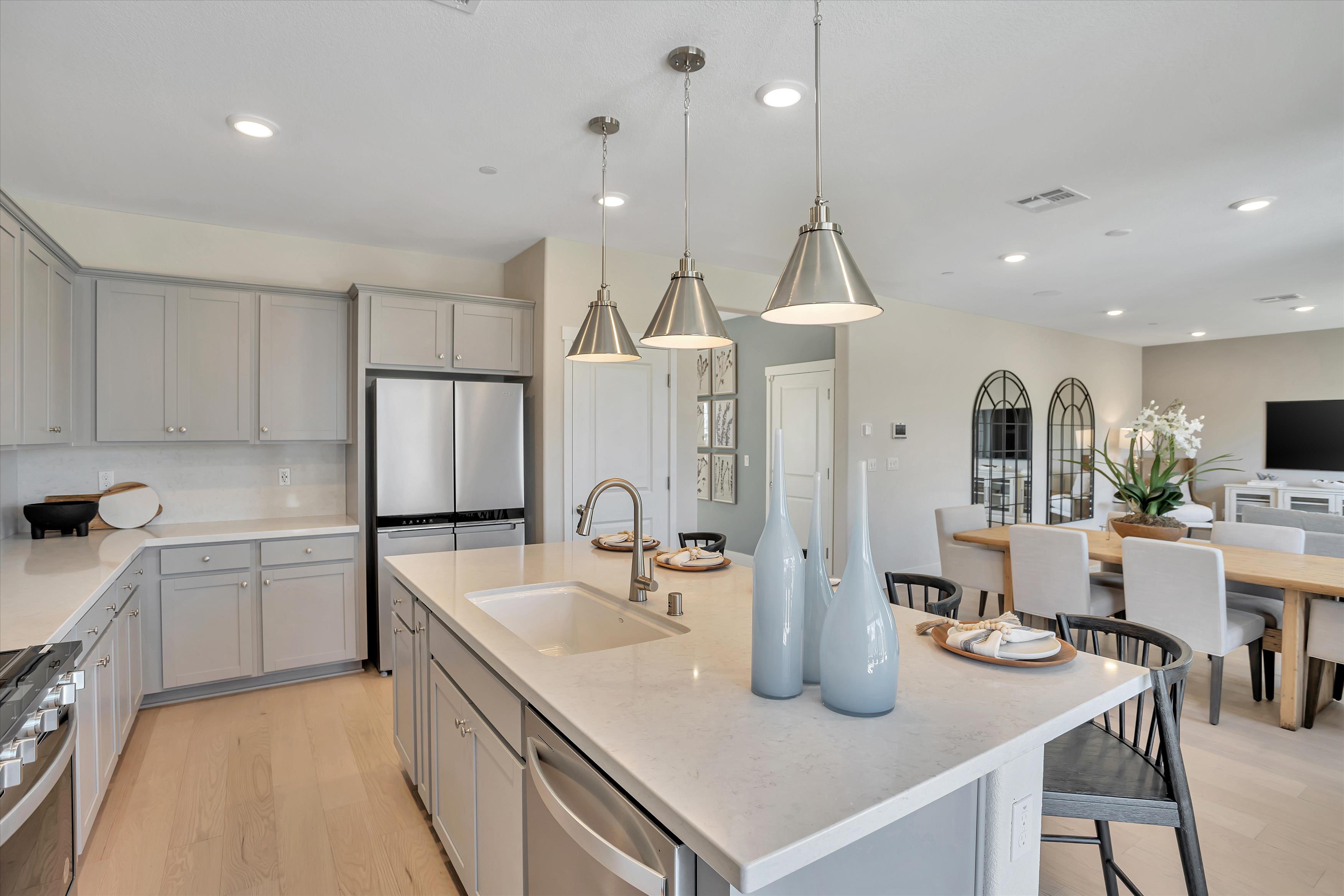 A kitchen with white cabinets.