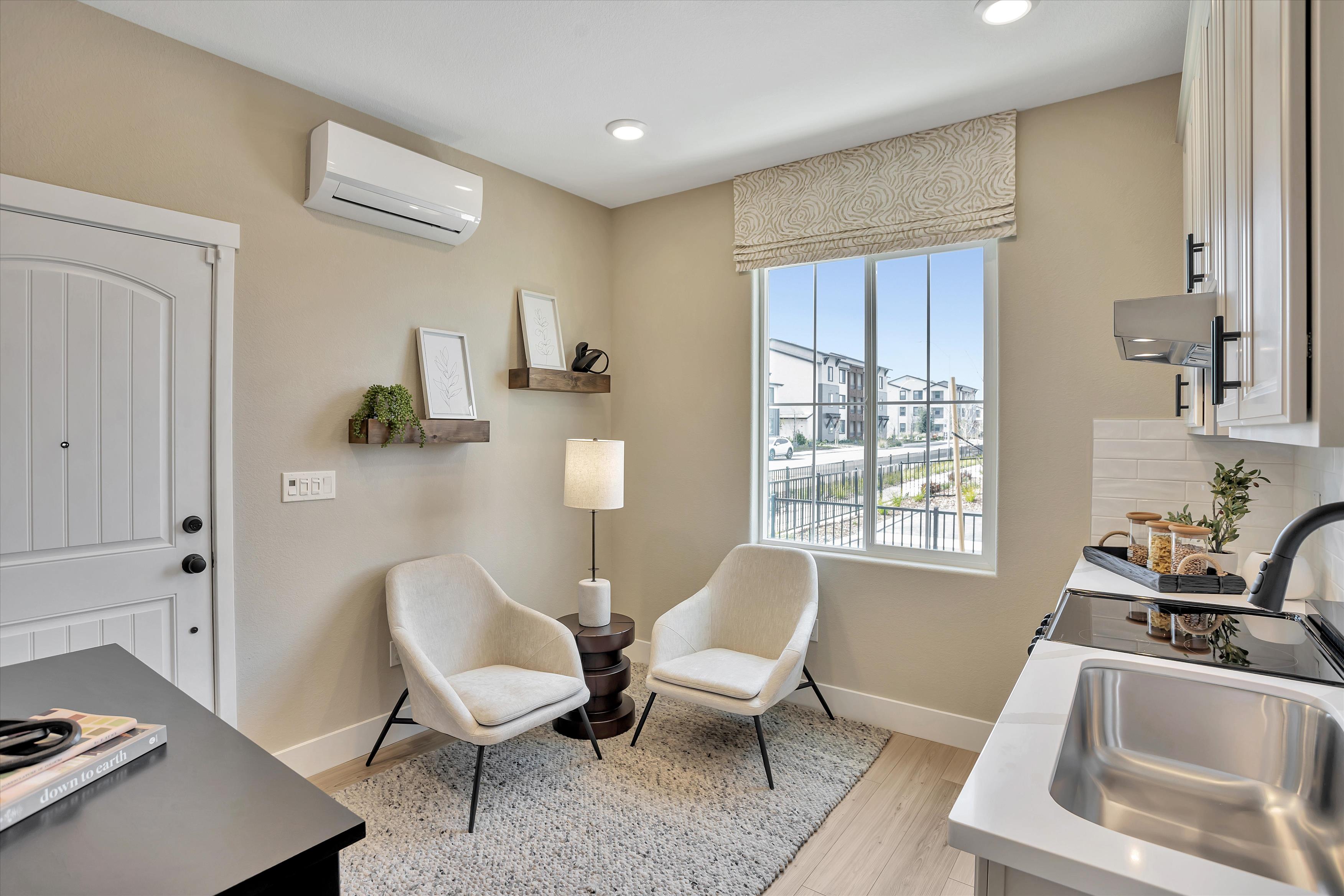 A bathroom with a sink and chairs.