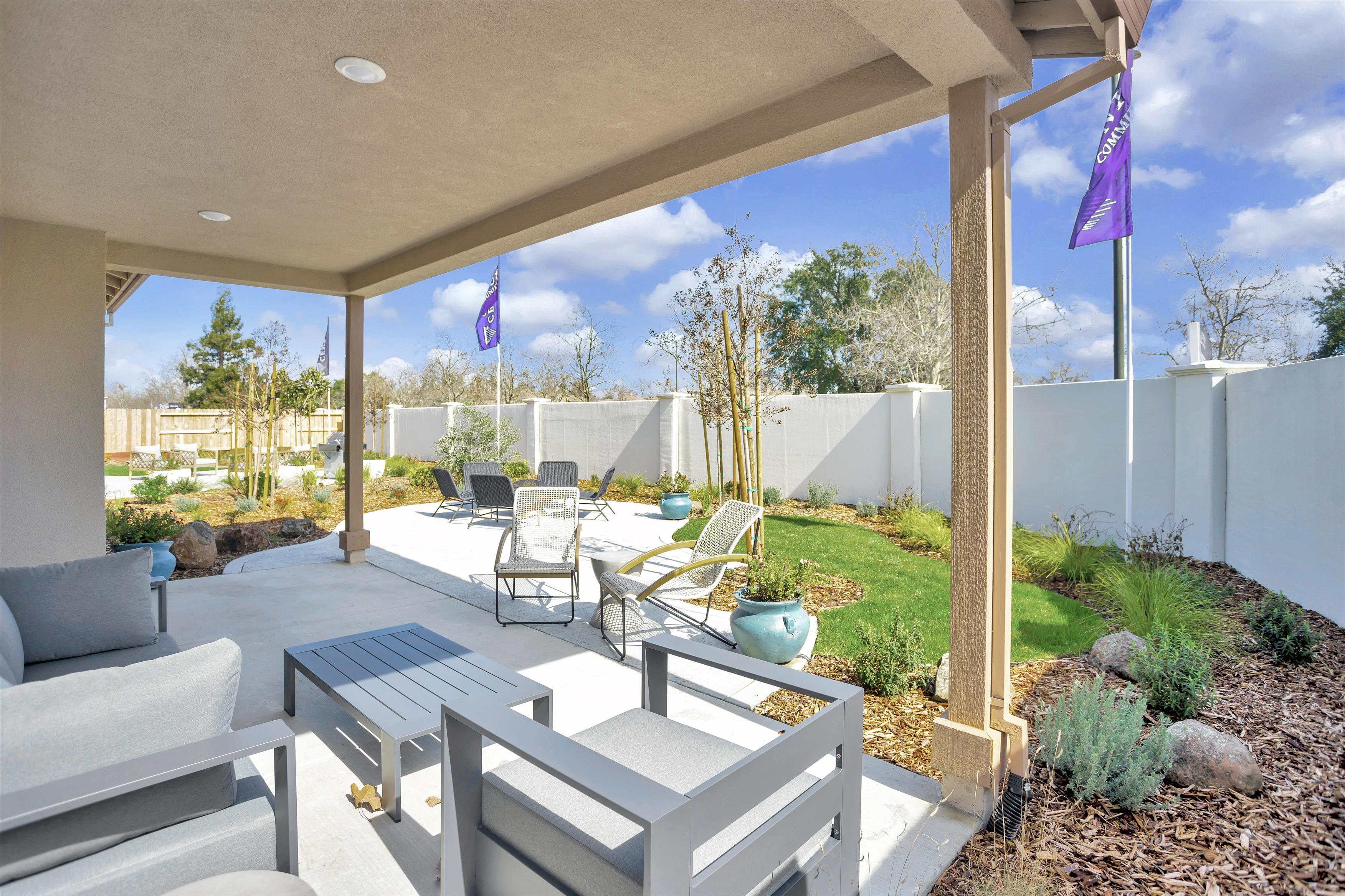 A patio with a table and chairs.