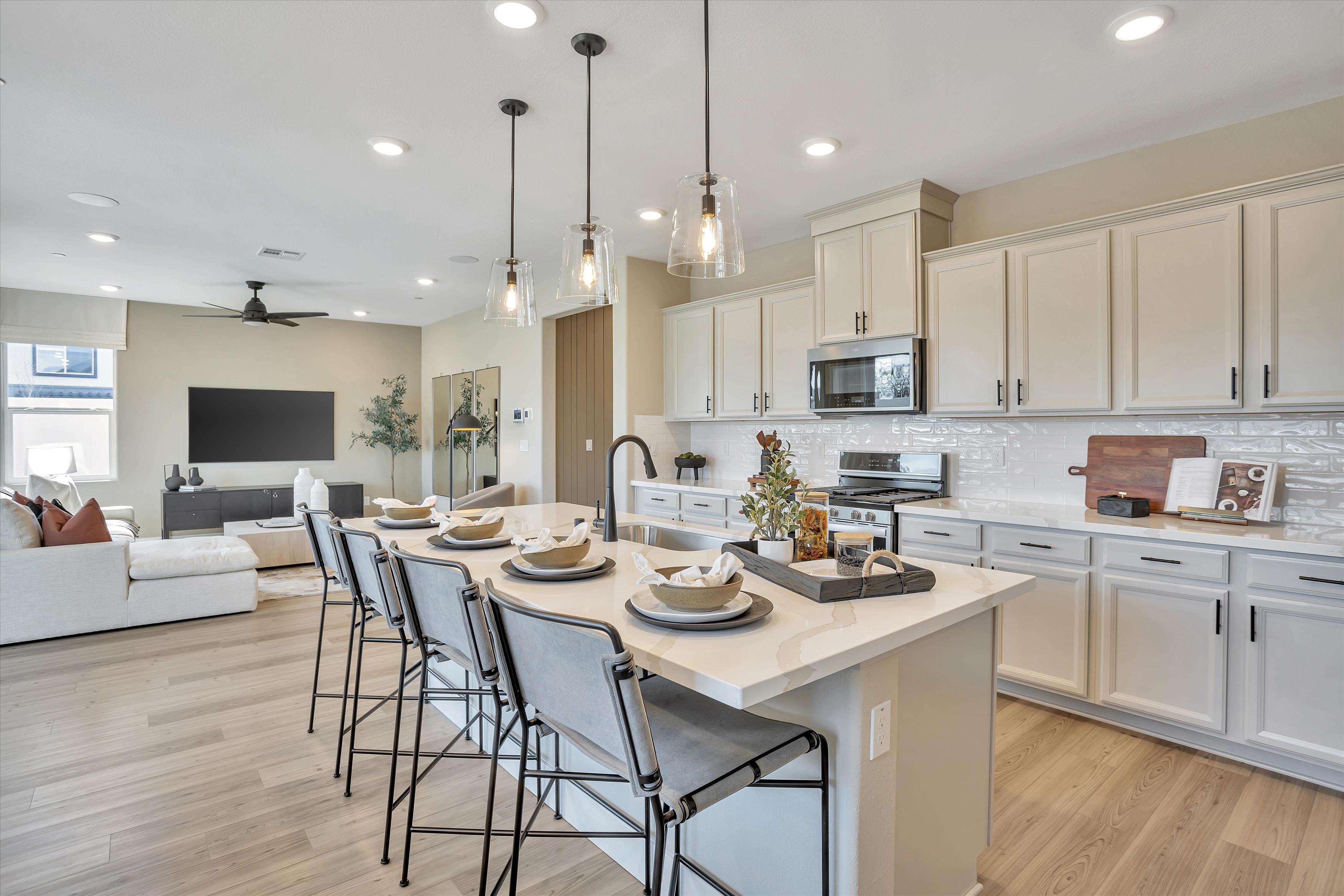 A kitchen with a dining table and white cabinets.