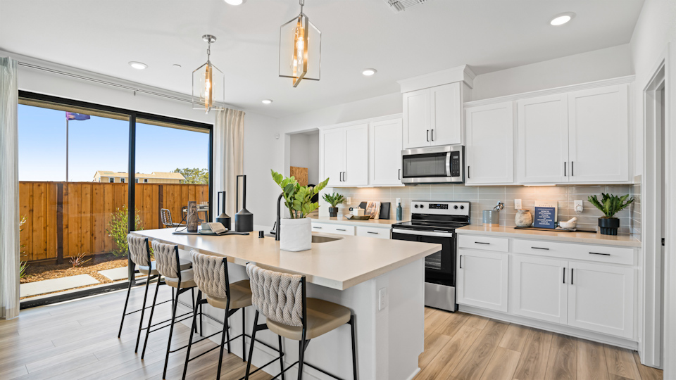 A kitchen with white cabinets.