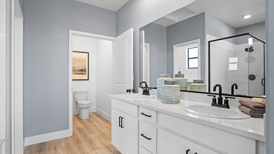 A bathroom with a large mirror.