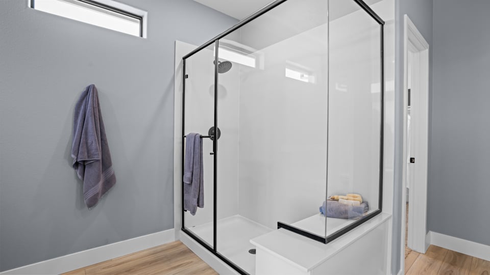 A shower with a glass door.