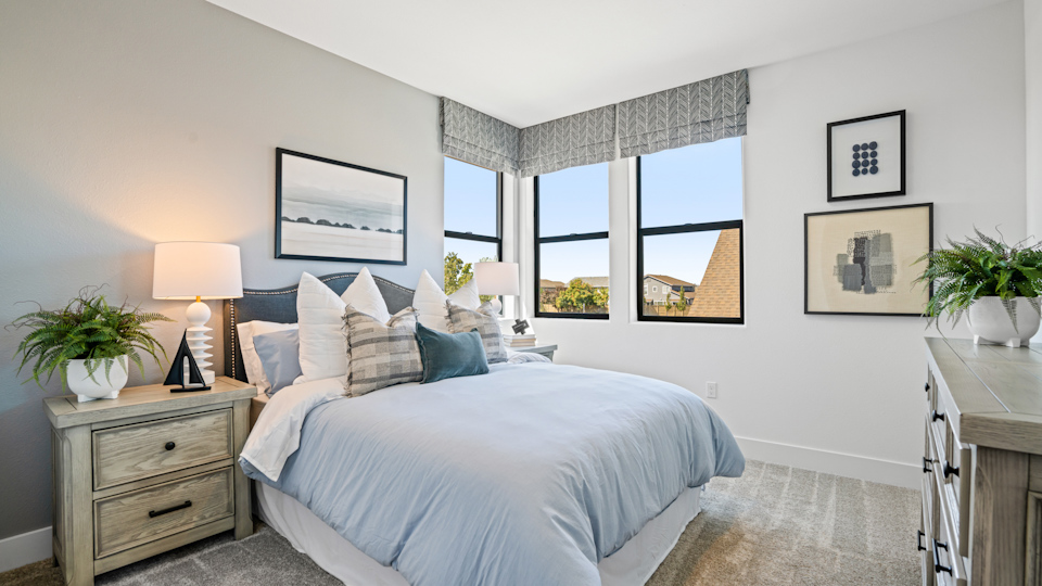 A bedroom with a bed and a window.