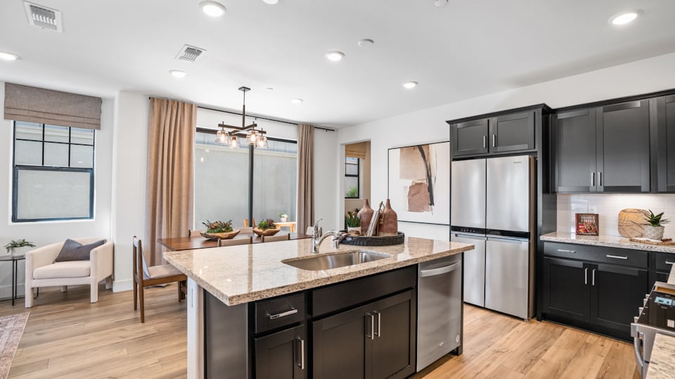 A kitchen with black cabinets.