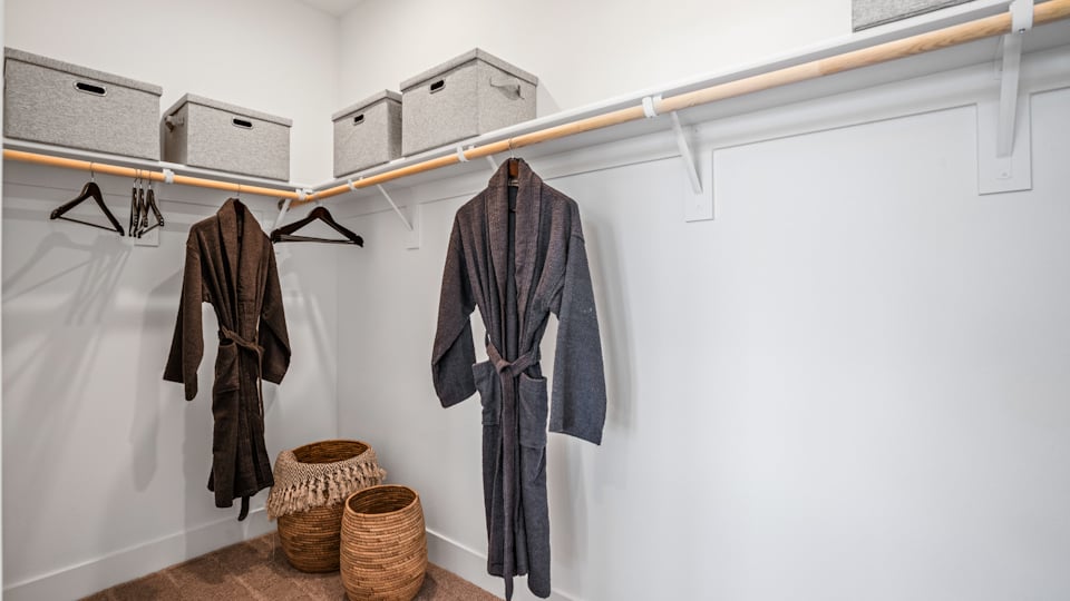 A room with clothes on the wall.