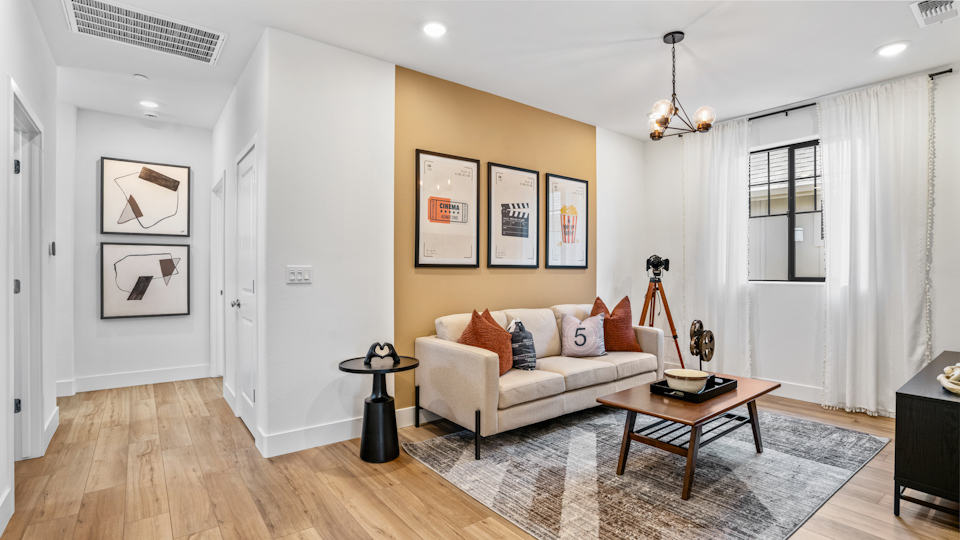 A living room with a couch and a rug.