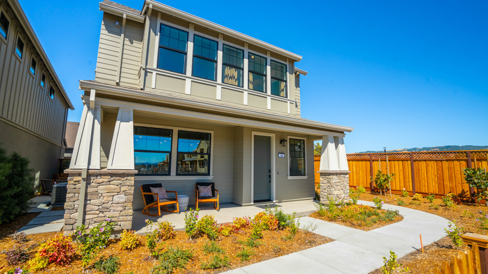 A house with a patio and chairs.