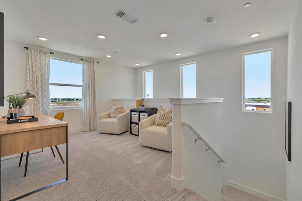 A living room with a table and chairs.