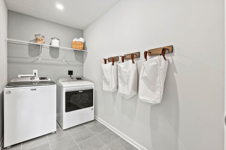 A kitchen with white towels on a rack.