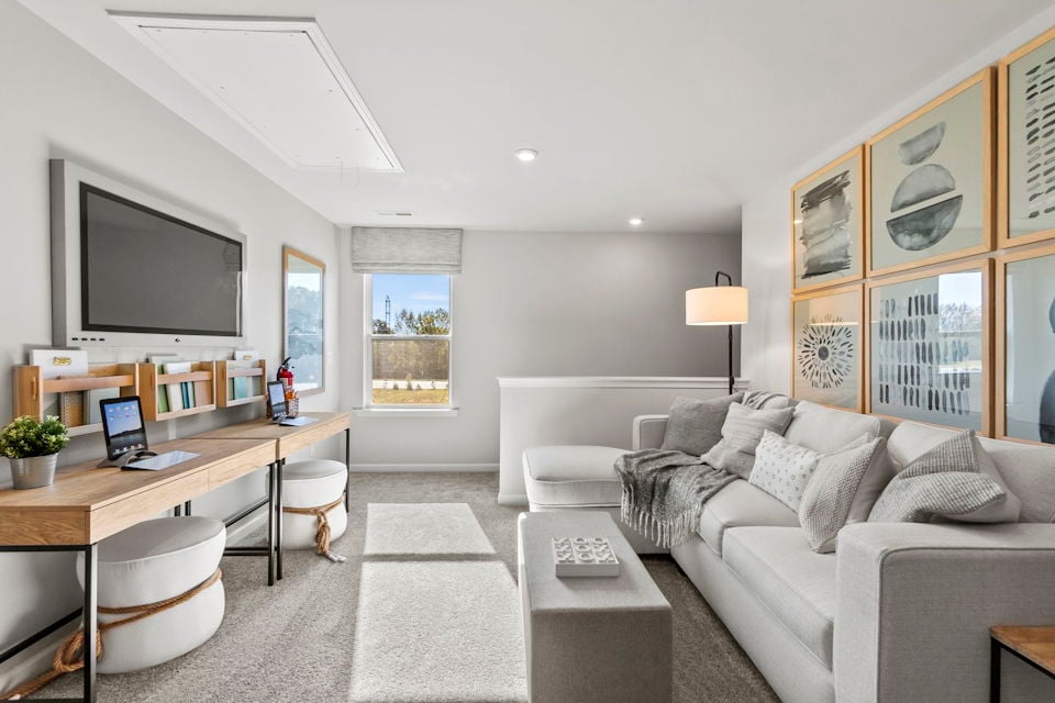 A living room with a large tv and a couch.